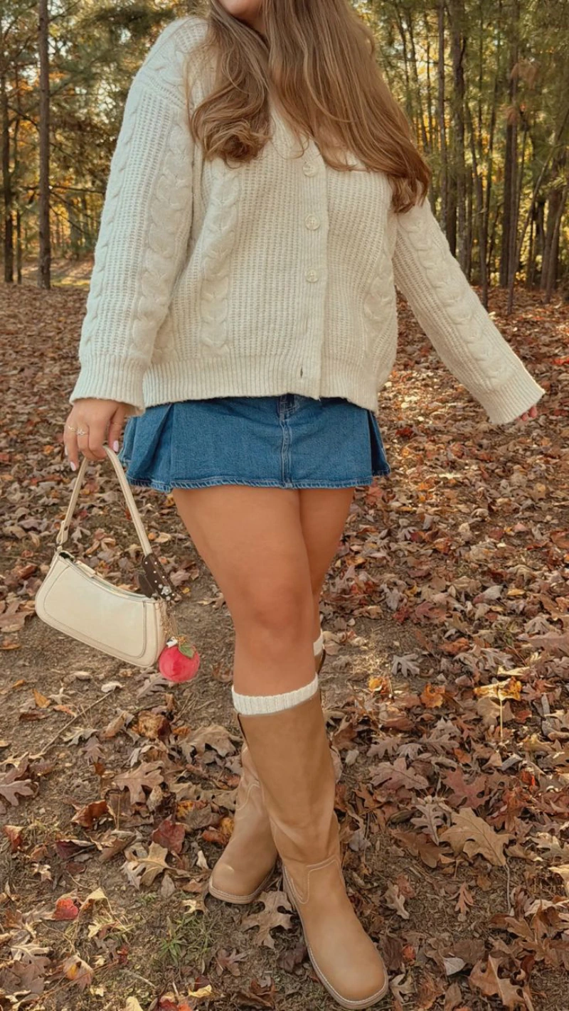 Cream Knit Cardigan + Pleated Denim Skirt + Tall Brown Boots + White Leg Warmers