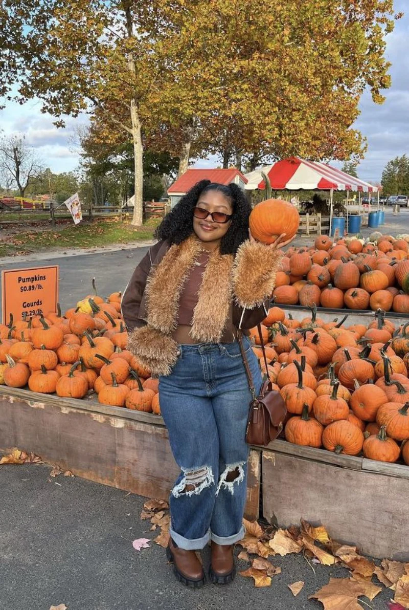 Fur-Trimmed Brown Jacket + Brown Crop Top + Ripped Blue Jeans + Dark Sunglasses